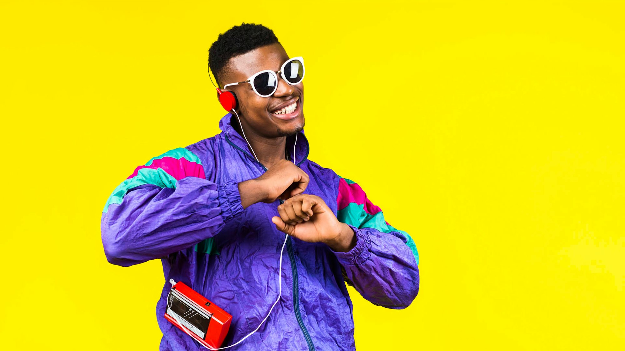 Man listening to music in headphones wearing 80's clothes