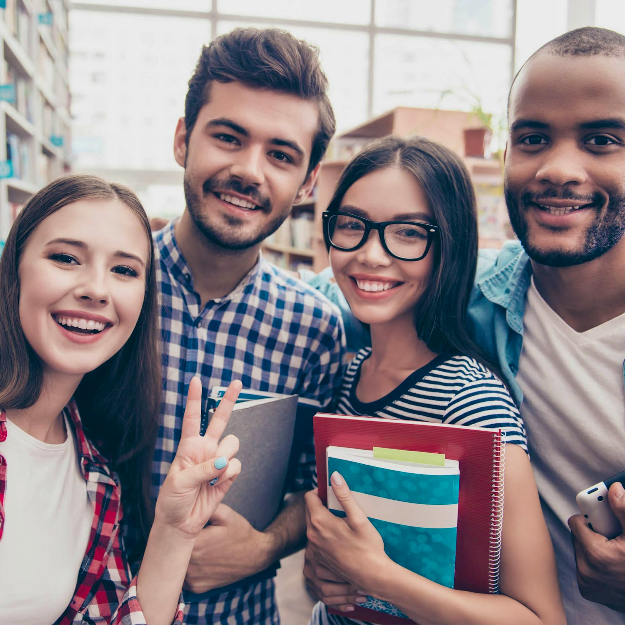 Students Holding Notepads Smiling for a Selfie
