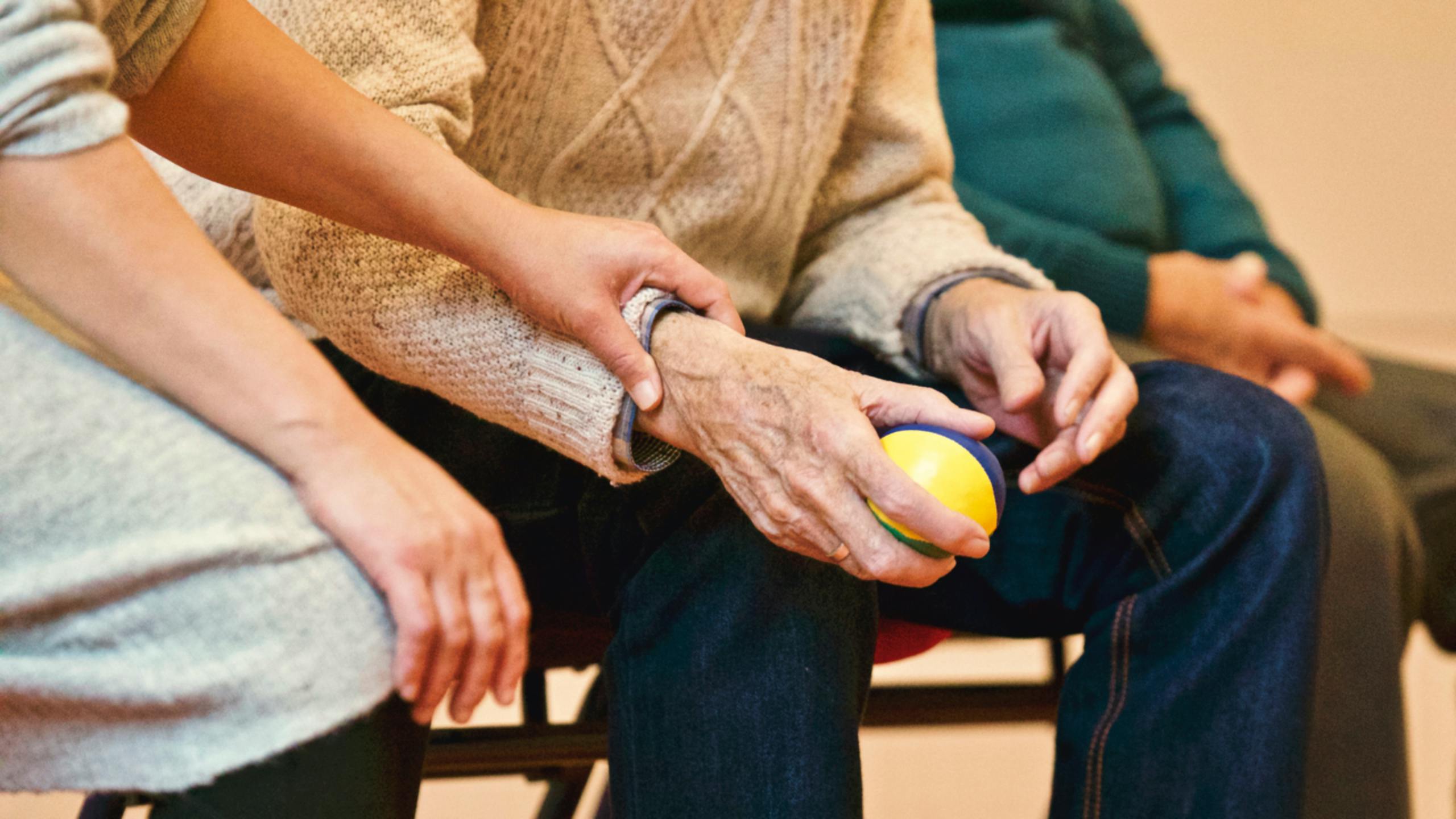 Elderly person in care-home being comforted by nurse