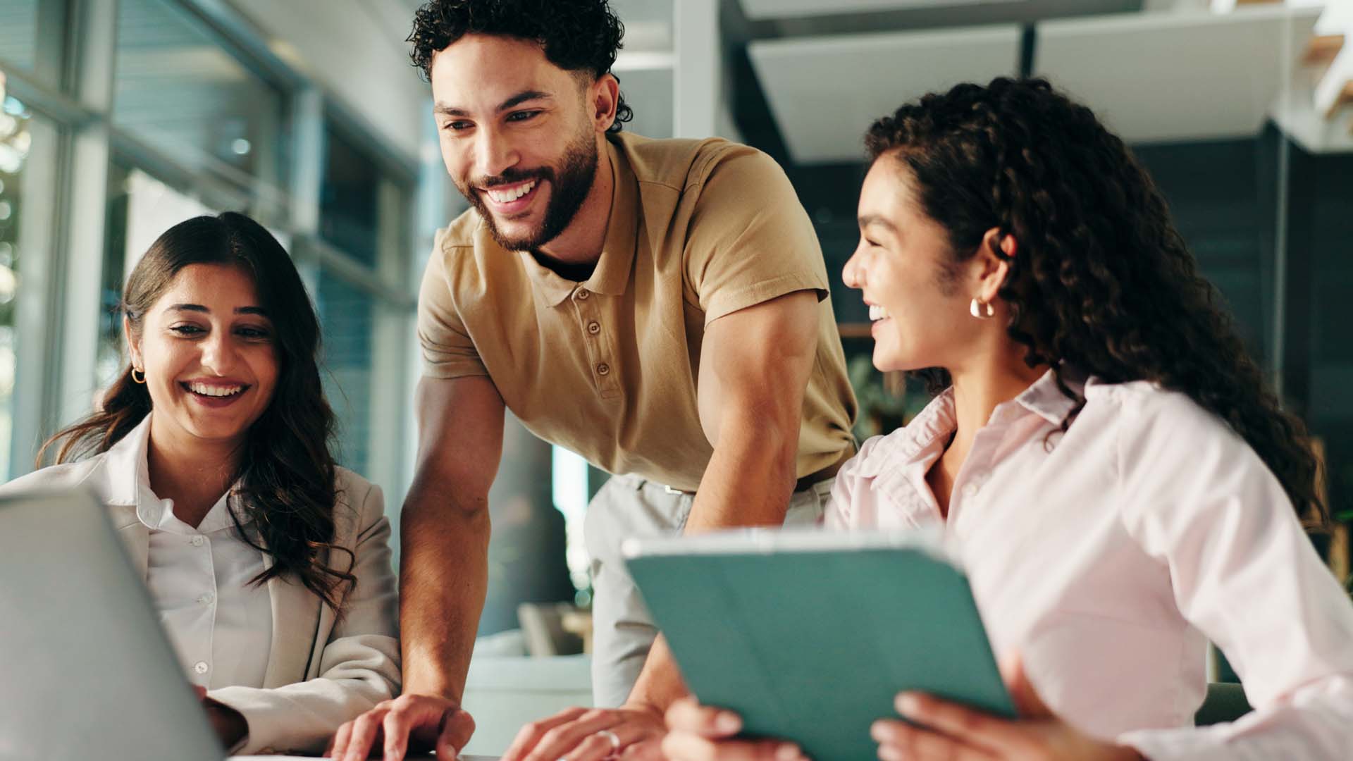 Colleagues discussing project whilst looking at computer and ipad