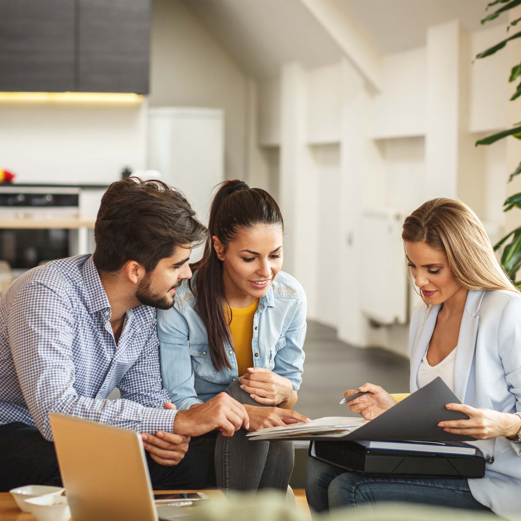 Male and Female colleagues laughing looking at a presentation