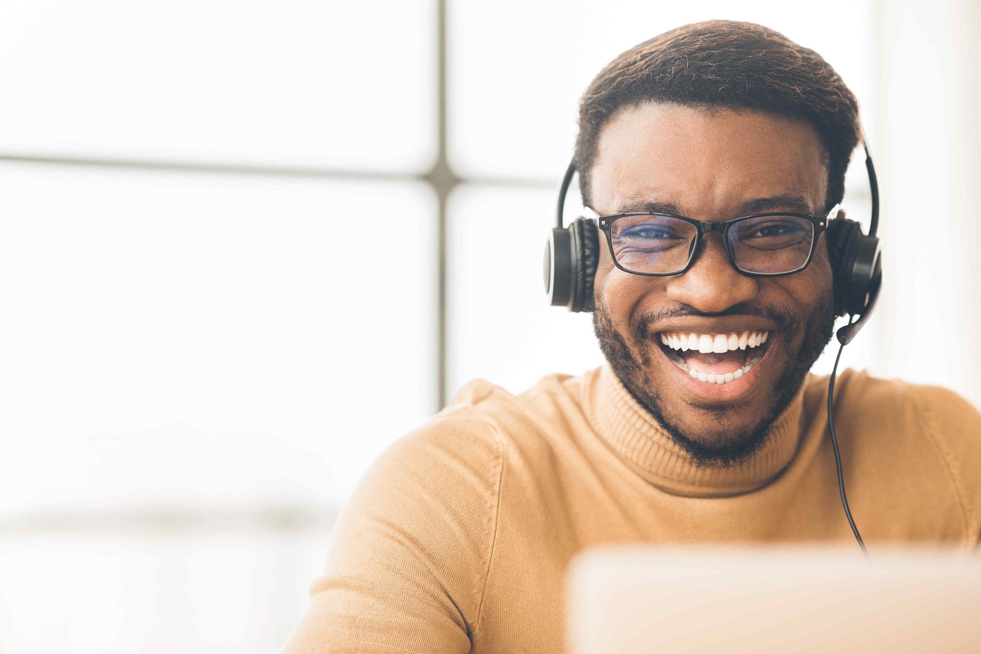 Man with headset on laughing