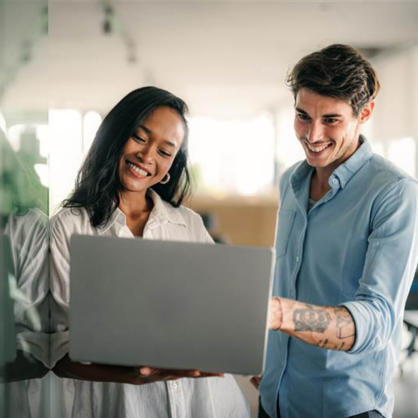 Man and Woman smiling at laptop