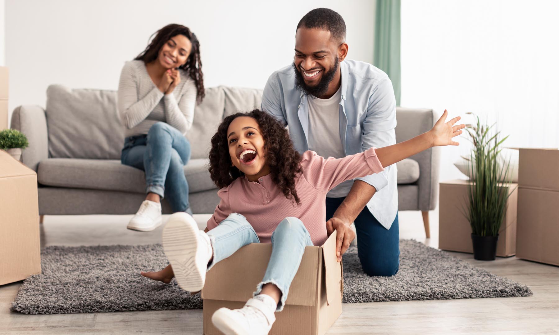 family with daughter laughing and playing
