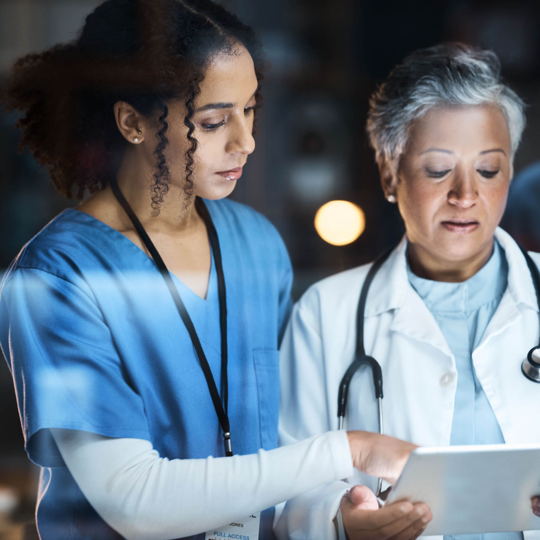 female medical coworkers looking at a patient chart