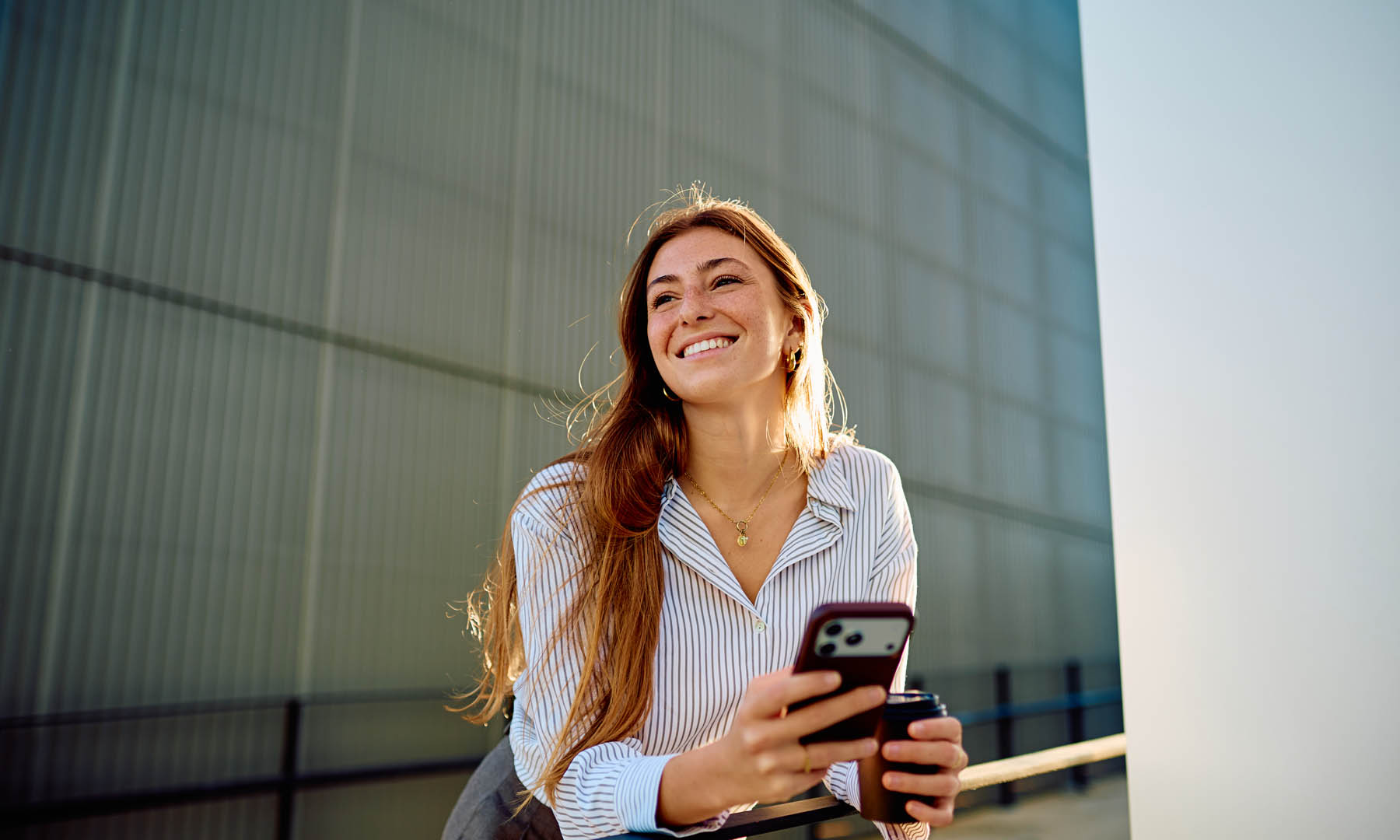 Woman leaning on railing smiling