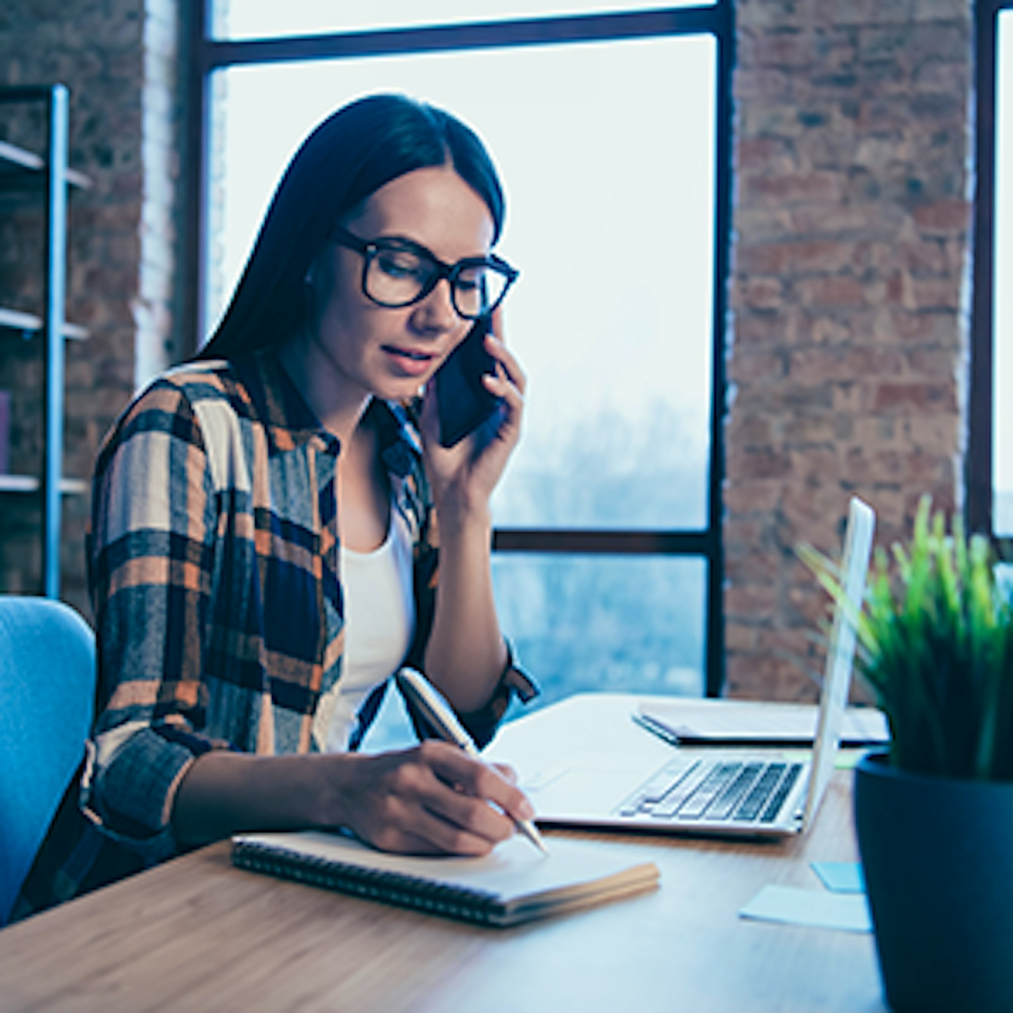 Woman on laptop and phone