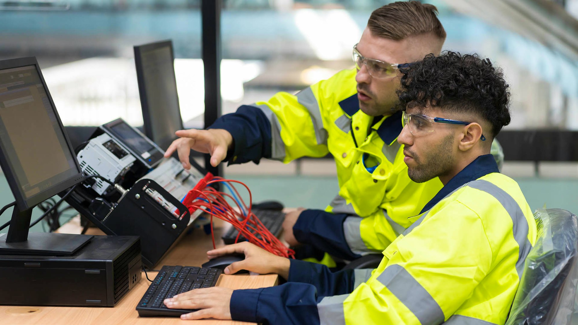 Teacher with Apprentice learning digital skills