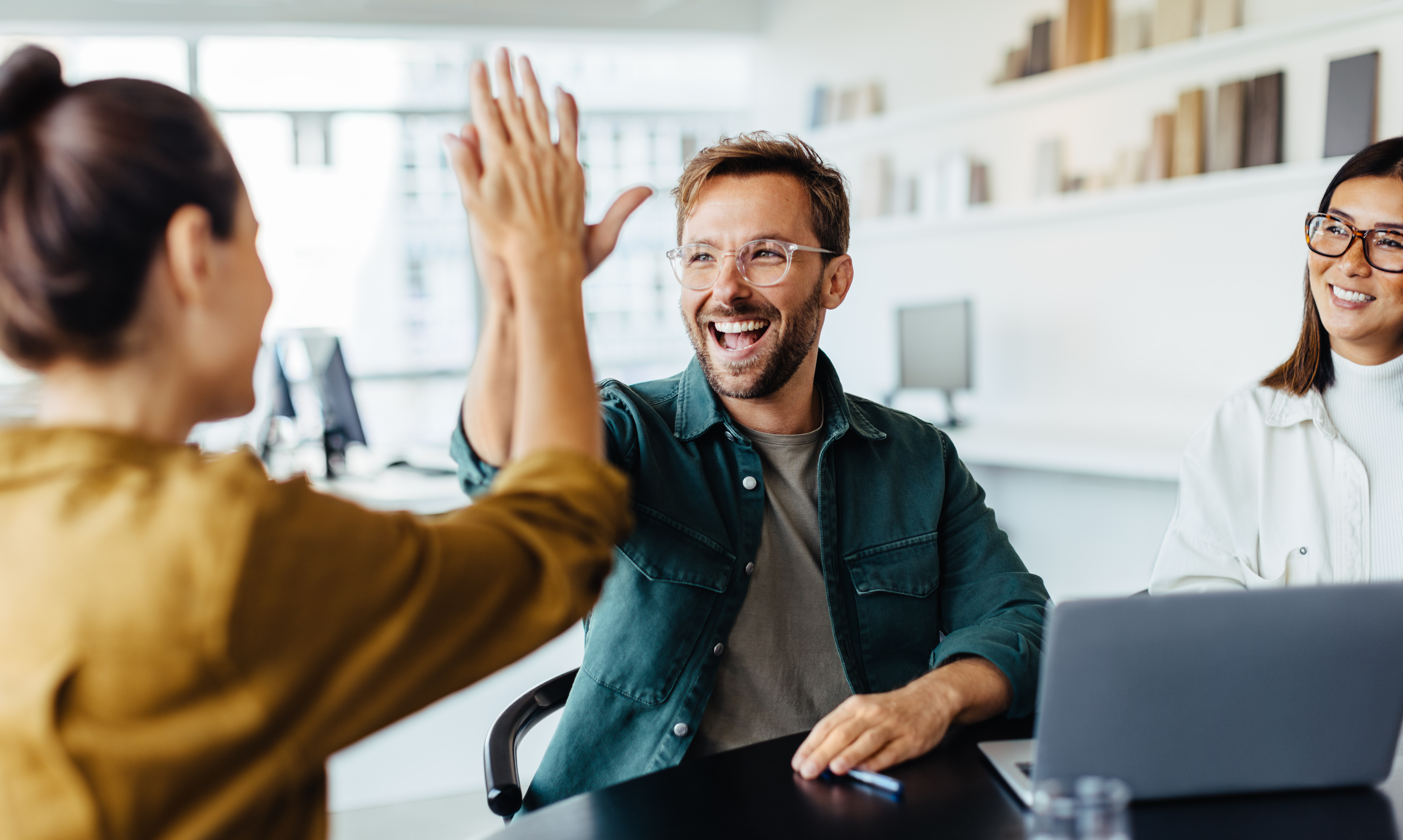 Man highfiving his colleague