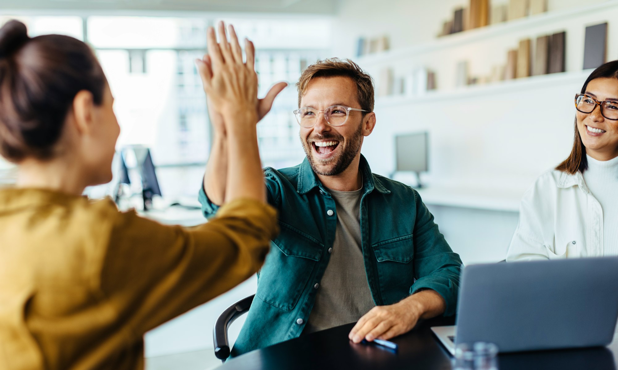 Man highfiving his colleague