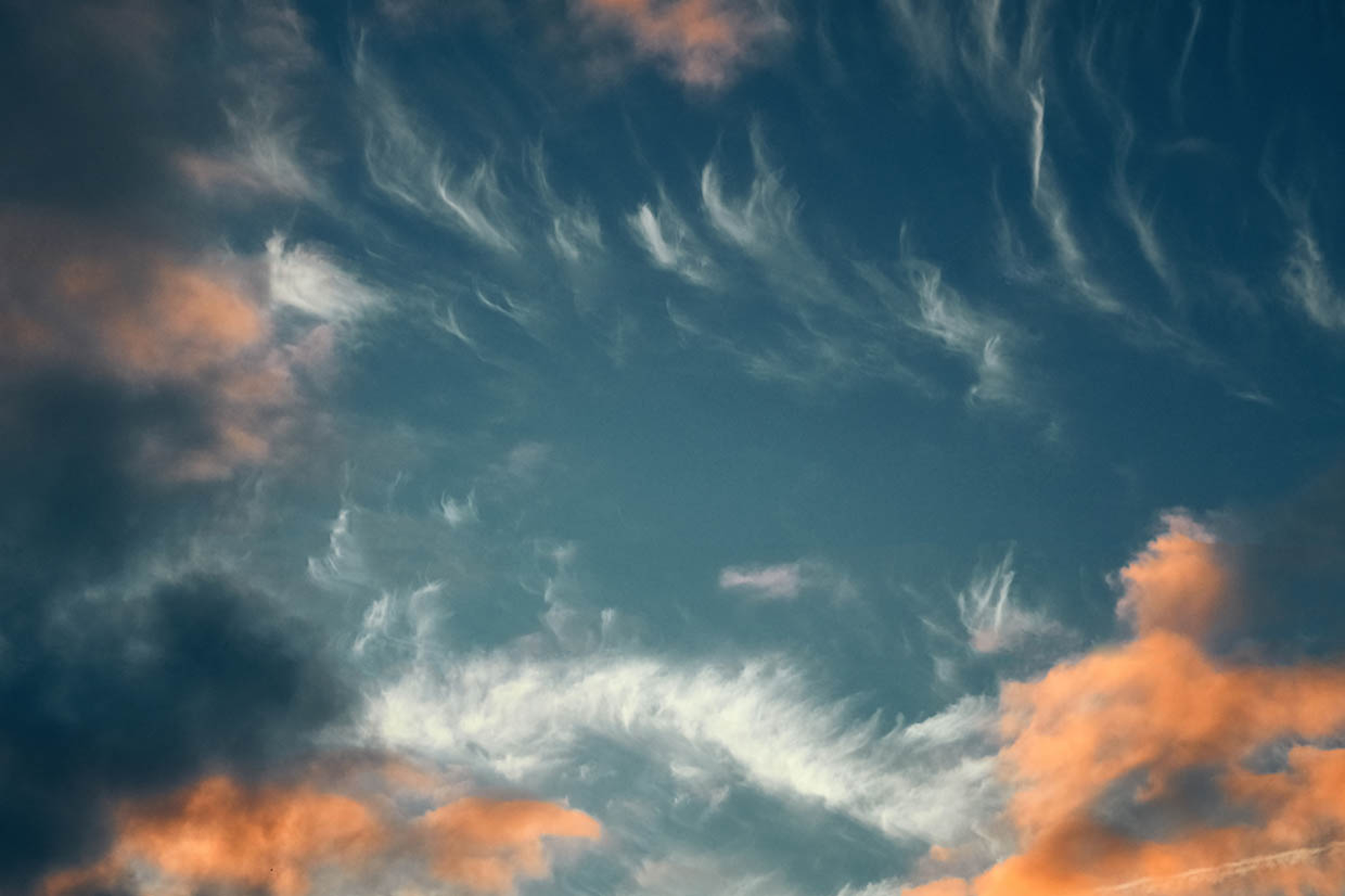 orange and blue sky with dispersed clouds