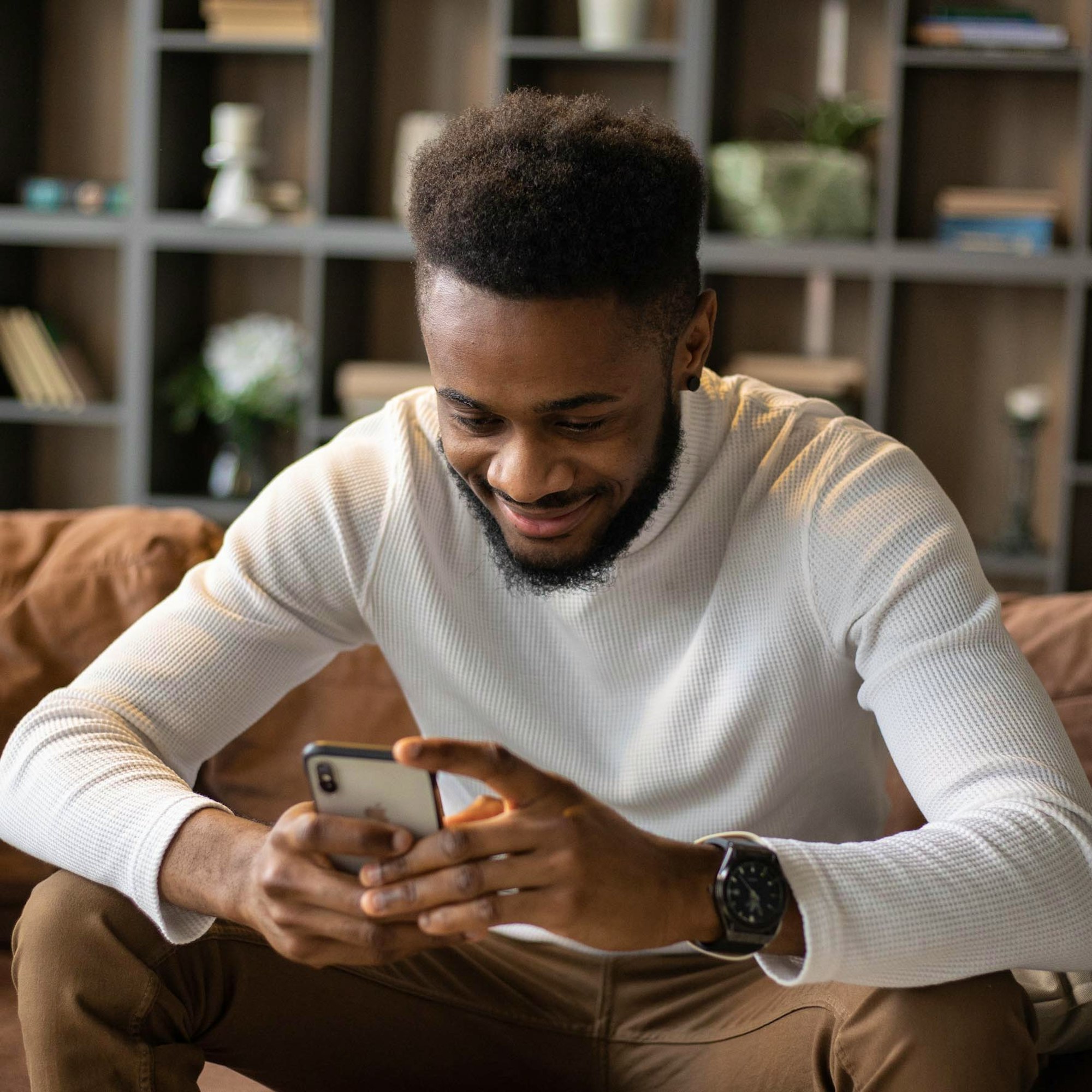 Man Smiling Looking at Phone